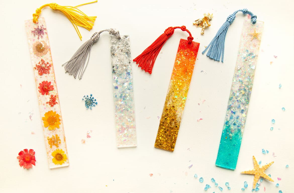 A group of colorful bookmarks with tassels and seashells.